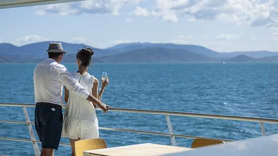 Couple enjoying the ocean view from cruise ship balcony in the Whitsundays