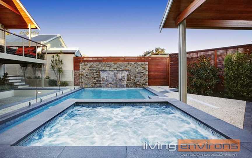 Custom concrete pool and spa with water feature wall. Designed and built by Living Environs.