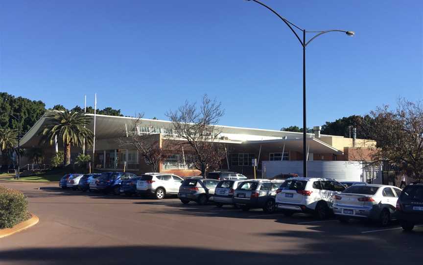 Modern single storey brick building viewed from car park