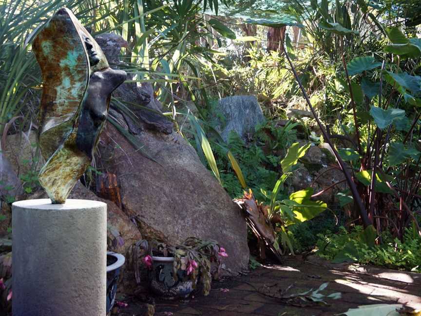 Emergence (left) is a concrete sculpture positioned at the 3 meter high granite rock waterfall built in 1995. Our rain forest jungle is a haven for small birds and 9 year old goldfish.